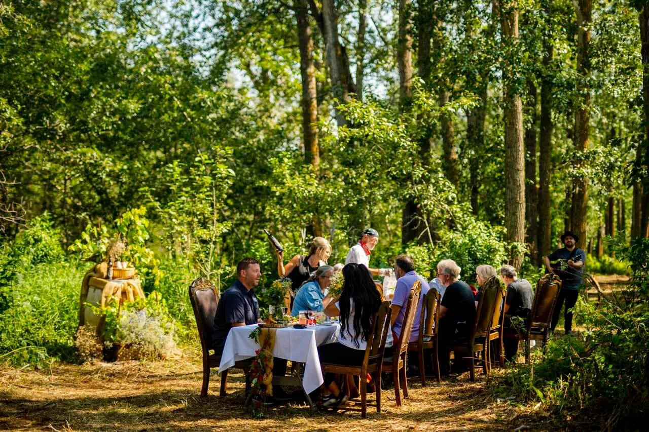 A group enjoying a shared meal outdoors at Prairie Gardens | Photo by Travel Alberta